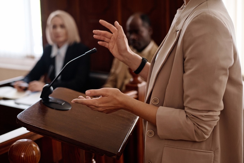 Cropped,Shot,Of,Young,Female,Witness,In,Beige,Blazer,Standing